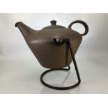 Clay kettle on metal stand