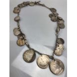 Hallmarked silver chain and Albert with a collection of various silver coloured coins total weight