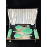 A silver and green enamel five piece dressing table set by Walker & Hall and a Silver hallmarked