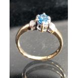 9ct yellow Gold ring set with approx 5.75mm x 4.15mm Marquess cut Blue Topaz with Diamonds to