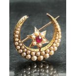 Victorian (Unmarked) Gold Seed Pearl and Ruby Crescent Brooch measuring approx: 28.3mm across. The