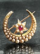 Victorian (Unmarked) Gold Seed Pearl and Ruby Crescent Brooch measuring approx: 28.3mm across. The