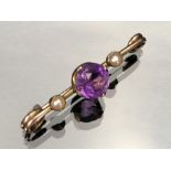 Gold unmarked Brooch set with seed pearls and a central Amethyst stone