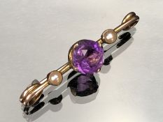 Gold unmarked Brooch set with seed pearls and a central Amethyst stone