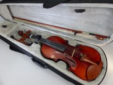 Violin in grey felt lined case, approx. 55cm in length.