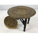 Indian Brass and Copper tea table with folding carved wooden legs and a second brass tray with