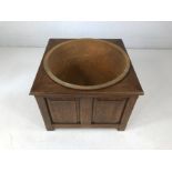 Large metal couldron in panelled wooden stand.