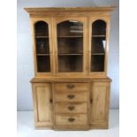 Pine dresser with four drawers with brass handles, two cupboards and shelves over