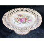 Cake stand with pierced rim and base with floral design to centre and base marked with blue