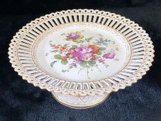 Cake stand with pierced rim and base with floral design to centre and base marked with blue