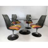 Oval glass topped retro dining table with four moulded retro chairs with striped upholstered seats