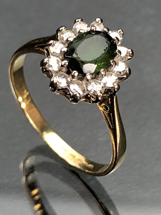 18ct yellow gold ring with large Oval faceted Peridot surrounded by twelve Diamonds (size 'Q' UK)