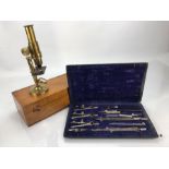 Vintage boxed microscope and a vintage compass set