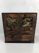 A Japanese Teisho period (1912-26) lacquered and specimen wood table cabinet, the interior with