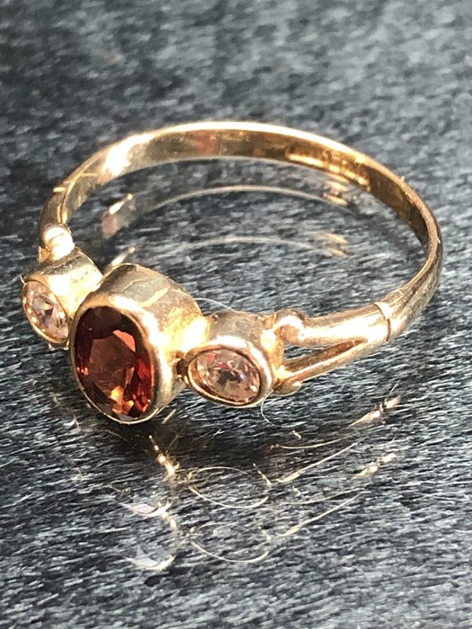 Three stone 9ct gold ring set with a central Oval Garnet (size 'J') - Image 4 of 4