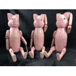 Three wooden decorative pink 'sitting pigs'