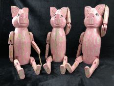 Three wooden decorative pink 'sitting pigs'