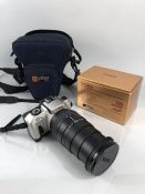 A Canon EOS IX7 camera with lens Sigma 28 - 200mm Hyperzoom Macro in carrying case