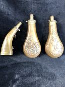 Three powder flasks, two brass and copper, the other horn and brass