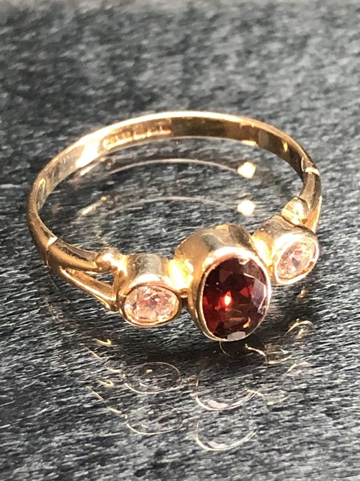 Three stone 9ct gold ring set with a central Oval Garnet (size 'J') - Image 3 of 4