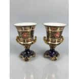 Royal Crown Derby - fine bone china urns with gilded twin handles and fluted necks. 1A/F