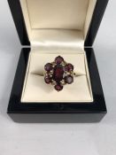 9ct Gold Garnet Cluster Ring. Centre stone approx:10mm x 8mm across surrounded by 6 approx: 5mm