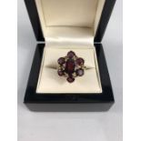 9ct Gold Garnet Cluster Ring. Centre stone approx:10mm x 8mm across surrounded by 6 approx: 5mm