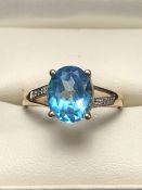 9ct Gold ring set with large faceted blue Topaz with Diamond Shoulders
