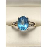 9ct Gold ring set with large faceted blue Topaz with Diamond Shoulders