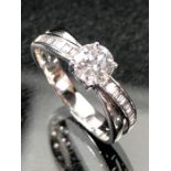 18ct white gold ring with central brilliant cut stone and cross over diamond shoulders