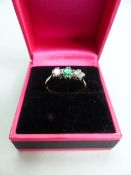 18ct Gold and Platinum Trilogy Ring, set with a central Emerald approx: 4.05mm with an approx: 0.