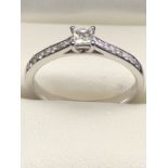 18ct White Gold and Diamond ring with central square cut Diamond and eight Diamonds to each shoulder