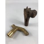 Two walking cane handles/ tops one decorative Brass and the other wooden carved Hippopotamus