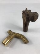 Two walking cane handles/ tops one decorative Brass and the other wooden carved Hippopotamus