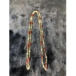 Yellow metal (possibly 18ct) trace link chain set with 18 small ‘torpedo’ links which are