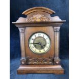 An Edwardian oak Mantle Clock, with gallery top over glazed door with Gilt dial, flanked by half