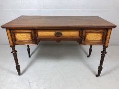 Three drawer Regency desk on ornately craved legs with castors, the drawers having Birdseye maple