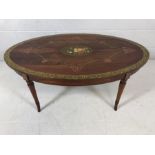 Oval occasional table with floral pattern