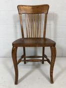 Single oak chair with spindle back and saddle seat