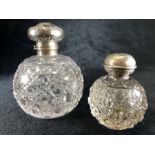 Two Glass perfume bottles with Birmingham hallmarked Silver lids and stoppers