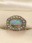 Georgian Mourning Ring set with an oval Black Opal measuring approx: 5.5mm x 10.3 across. Surrounded