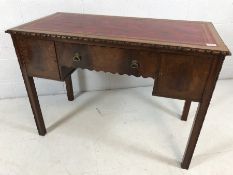 Red leather topped desk with drawer and two small cupboards under approx 107cm x 54cm x 76cm tall