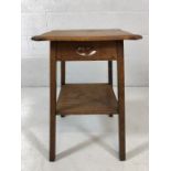 Arts and crafts style oak occasional table with serpentine top tier