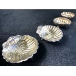 A set of four silver hallmarked scallop shell shaped salts