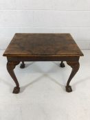 Walnut side table of book match walnut veneer on ball and claw feet