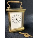A 19thC brass carriage clock, of rectangular form with exterior swing handle, the rectangular dial