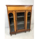 Glazed display cabinet on six turned legs with castors, two velvet-lined shelves, single glazed door