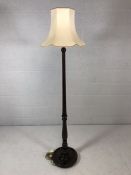 Dark mahogany stained circular based standard lamp