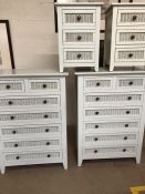 White wood and wicker bedroom furniture , consisting of two chests of seven drawers , and two