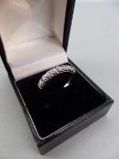 18ct White Gold Half Hoop ET Ring, set with 9 approx: 0.05ct Brilliant cut diamonds. Size approx: ‘